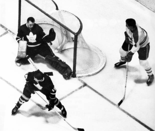 The Toronto Maple Leafs in action against the Montreal Canadiens at Maple Leaf Gardens in Toronto, April 8, 1965. Richard (not shown) cashed Beliveau's pass-out in front of Leafs' Douglas.