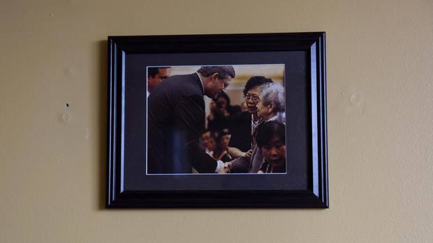 A photo of Foon Hay Lum with former Prime Minister Stephen Harper hangs in her room in her retirement home in Toronto on January 13, 2017.