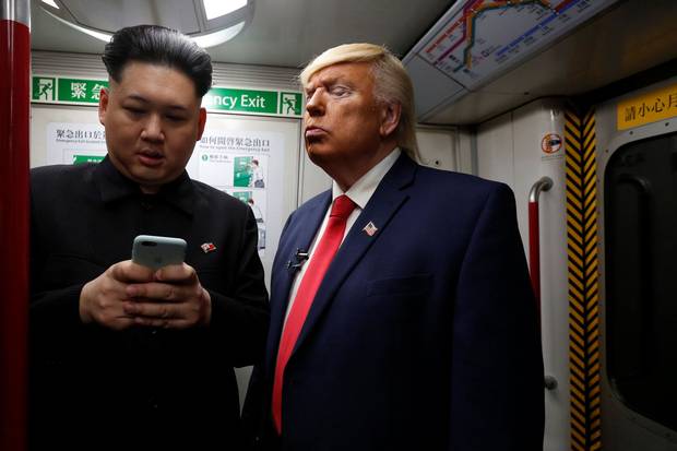 Two impersonators of North Korean leader Kim Jong-un and U.S. President Donald Trump, ride a subway train in Hong Kong on Jan. 25, 2017.