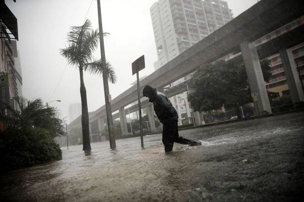 Miami, Sept. 10: A local resident walks across a flooded street.