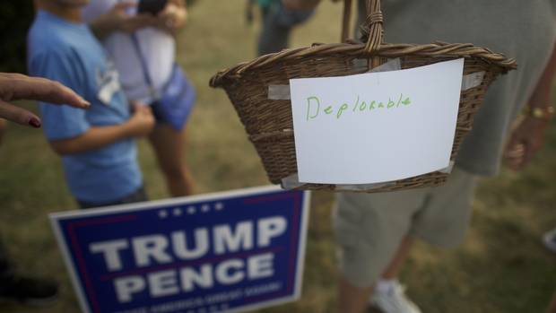 A Trump supporter holds a basket labeled “deplorable,” referencing Ms. Clinton’s comment about a “basket of deplorables,” at a campaign event in Aston, Pa., on Sept. 13, 2016.