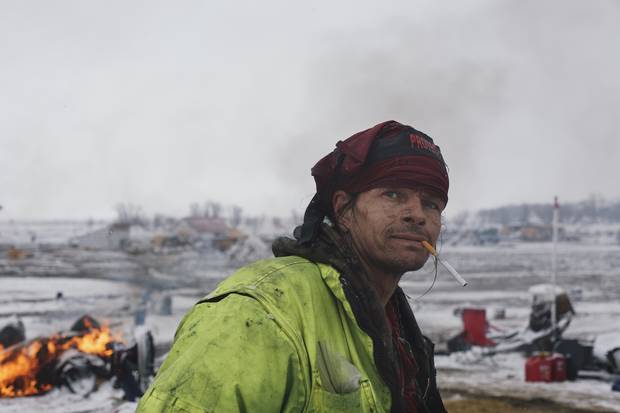 A protestor monitors clean up fires on the morning ahead of Army Corp of Engineers eviction at the DAPL resistance camps near Cannon Ball, North Dakota February 22.