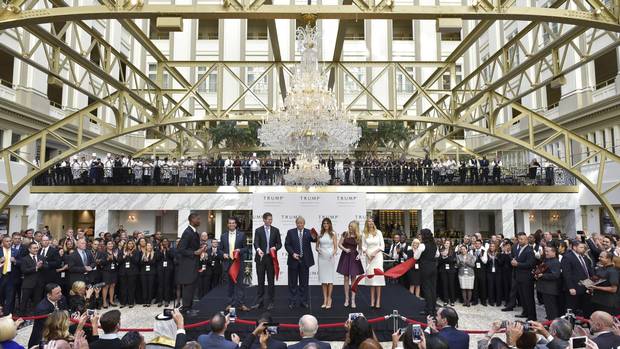 From left: Donald Trump Jr, Eric Trump, Republican presidential nominee Donald Trump, Melania Trump, Tiffany Trump, and Ivanka Trump take part in a ribbon cutting ceremony during the grand opening of the Trump International Hotel in Washington, DC on October 26, 2016