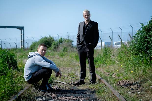 Ewan McGregor as Mark Renton and Jonny Lee Miller as Simon on railway tracks in TriStar Pictures' T2: Trainspotting. 