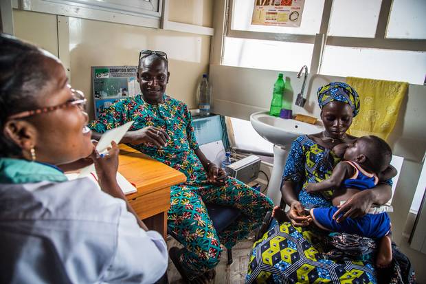 Simplicia Zannou and her husband Kokossou Bourasma consult a nurse about birth control on a mobile clinic boat in the So-Ava commune of Benin. Simplicia will find out later she is pregnant.
