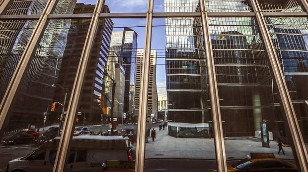 Buildings reflected in glass in Toronto’s Financial District, on Thursday January 22, 2015.