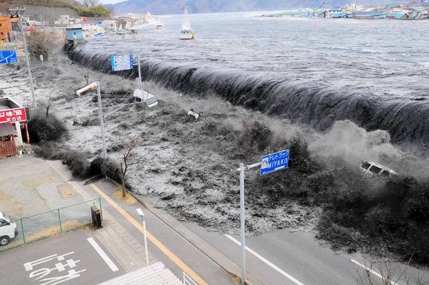 A wave approaches Miyako City from the Heigawa estuary after a magnitude 8.9 earthquake struck the area on March 11, 2011.