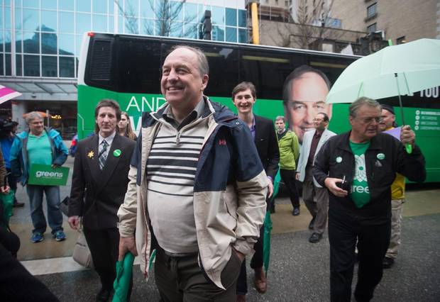 British Columbia Green Party Leader Andrew Weaver, front left, walks to a news conference after unveiling his new election campaign bus in Vancouver on April 6, 2017.