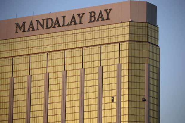 Drapes billow out of broken windows at the Mandalay Bay Resort and Casino on the morning after the shooting.