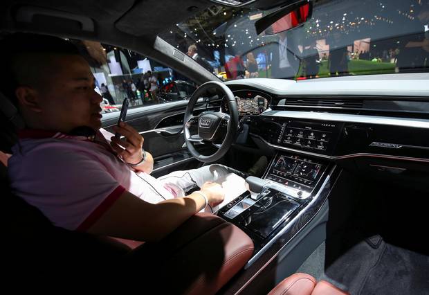 A man views the interior of the new Audi A8.