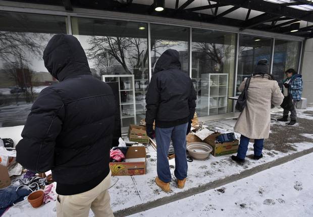 Unaware that the Goodwill store and drop off location at 60 Overlea Blvd was closed, shoppers sort through items left outside the store.