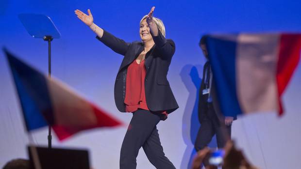 Far-right leader and candidate for the 2017 French presidential election Marine Le Pen acknowledges applause as she arrives on stage for a meeting in Marseille, southern France, on April 19, 2017.