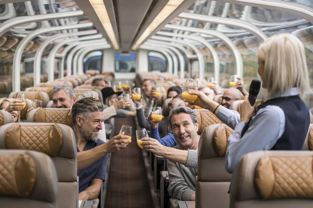 Travellers have a morning toast onboard a Rocky Mountaineer train.