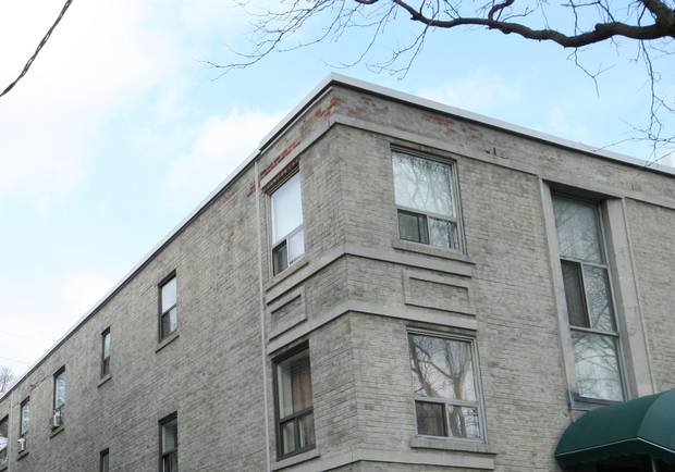 Worn-away paint reveals red brick at 470 Summerhill Ave.