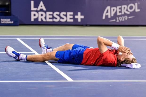 MONTREAL, QC - AUGUST 10: Denis Shapovalov of Canada falls to the ground after his victory over Rafael Nadal of Spain during day seven of the Rogers Cup presented by National Bank at Uniprix Stadium on August 10, 2017 in Montreal, Quebec, Canada. Denis Shapovalov of Canada defeated Rafael Nadal of Spain 6-3, 4-6, 6-7. (Photo by Minas Panagiotakis/Getty Images)