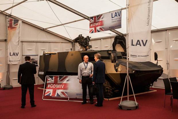 David Hind, right, with a LAV at the London conference; his current brief is to persuade the British Army to buy.