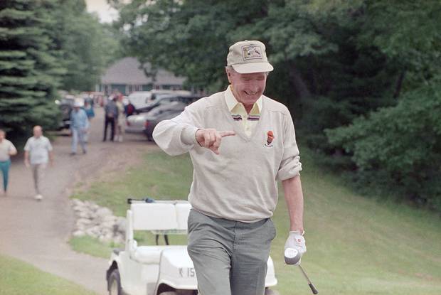 July 3, 1989: U.S. president George H. Bush pauses with a tee in his mouth while playing golf at the Cape Arundel Golf Club in Kennebunkport, Me.