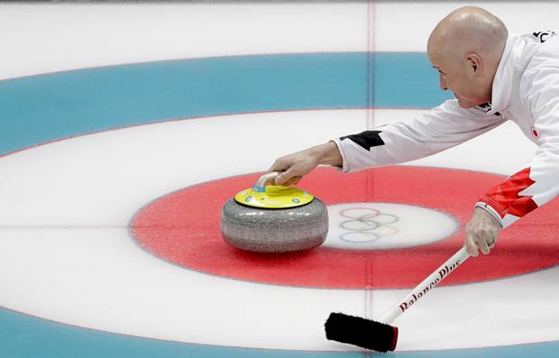 Canada's skip Kevin Koe throws a stone during a men's curling match against at Switzerland the 2018 Winter Olympics in Gangneung, South Korea, Sunday, Feb. 18, 2018.