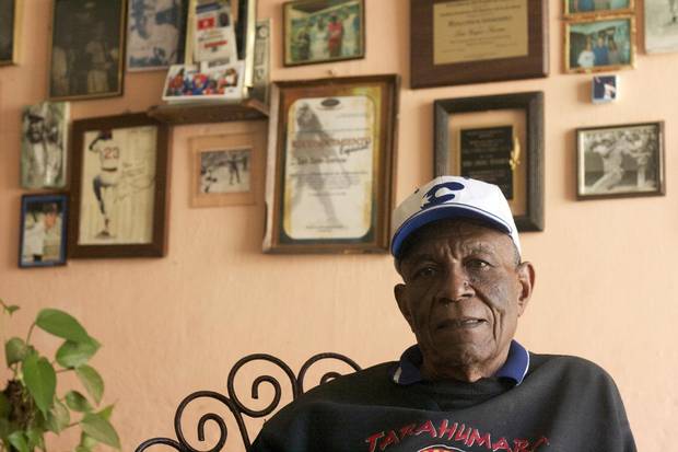 Luis Zayas, a former Havana Sugar Kings player, with photographs of Cuban players on his wall in Havana, March 7, 2013. For more than six seasons in prerevolutionary Cuba, the Sugar Kings were the Cincinnati Reds' Class AAA affiliate in Havana.