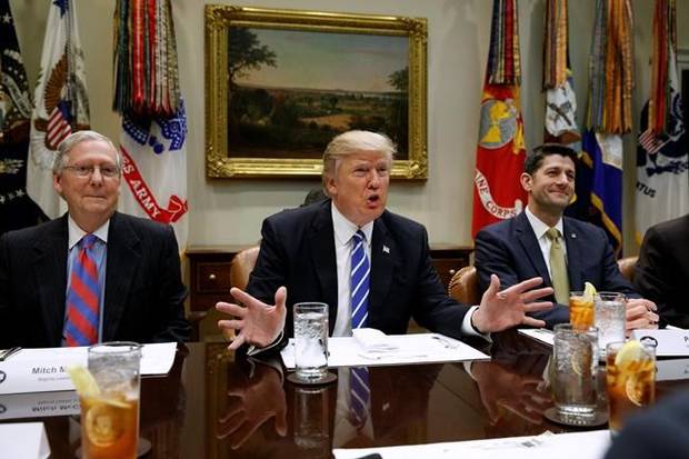 President Donald Trump, flanked by Senate Majority Leader Mitch McConnell of Ky., left, and House Speaker Paul Ryan of Wis., speaks during a meeting with House and Senate leadership.