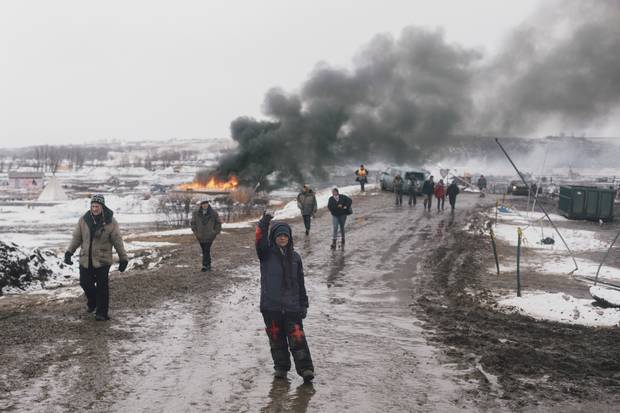A woman raises her fist as many people leave the Oceti Sakowin camp for the last time during the Army Corp of Engineers eviction at the DAPL resistance camps near Cannon Ball, North Dakota February 22.