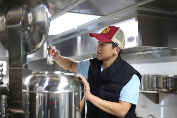 Mr. Yim checks the temperature of his Pyongyang naengmyeon, which is chilled to just above freezing.