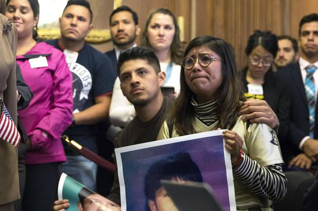 Jairo Reyes and Karen Caudillo, both DREAMers, listen during a news conference in Washington on Wednesday.
