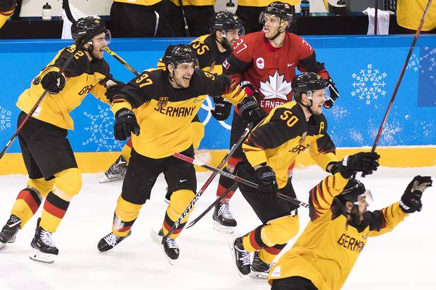 Feb. 23, 2018: Canadian defenceman Mat Robinson looks on as German players celebrate after a men's semifinal Olympic hockey game, where they defeated Canada to advance to the gold medal game.