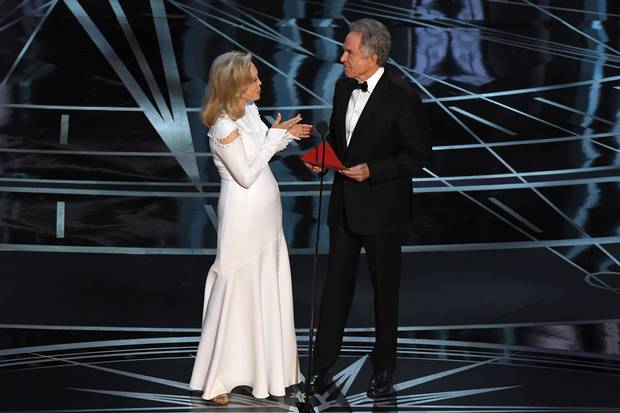 Actress Faye Dunaway and actor Warren Beatty arrive on stage to announce the winner.