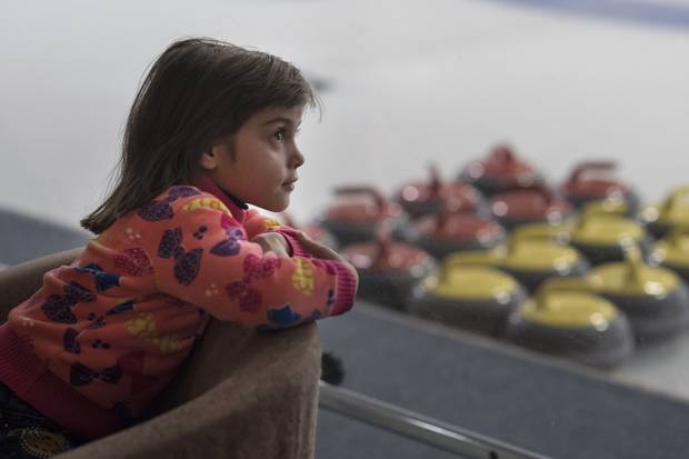 Haneen Khalifih, 6, (from Syria) looks out over the curling rinks while on a day trip to the Royal Canadian Curling Club.