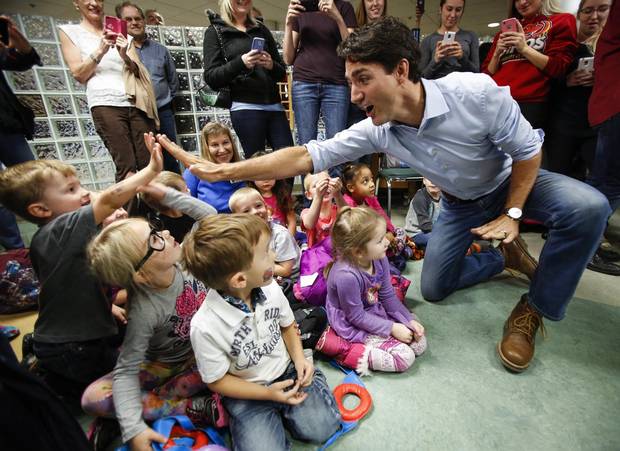 Prime Minister Justin Trudeau high fives pre-schoolers at Medicine Hat College on Oct. 14, 2016.