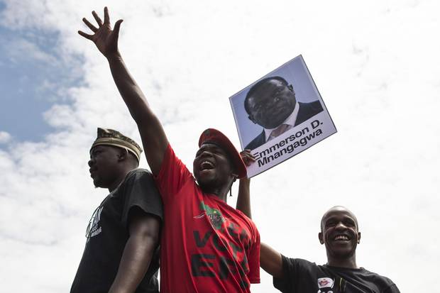 University of Zimbabwe students, holding a portrait of Emmerson Mnangagwa, take part in a demonstration on in Harare on Nov. 20, 2017.