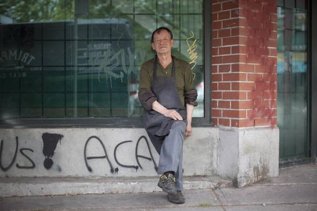 A worker from Tin Lee Market in Vancouver's Chinatown takes a break.