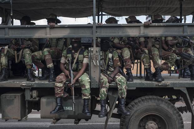 Soldiers sit on a military truck upon the arrival of Zimbabwe's ousted vice-president Emmerson Mnangagwa in Harare on Nov. 22, 2017.