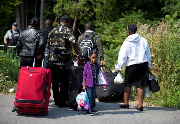 A family that stated they were from Haiti line up to cross the border into Quebec from New York on Aug. 21, 2017.