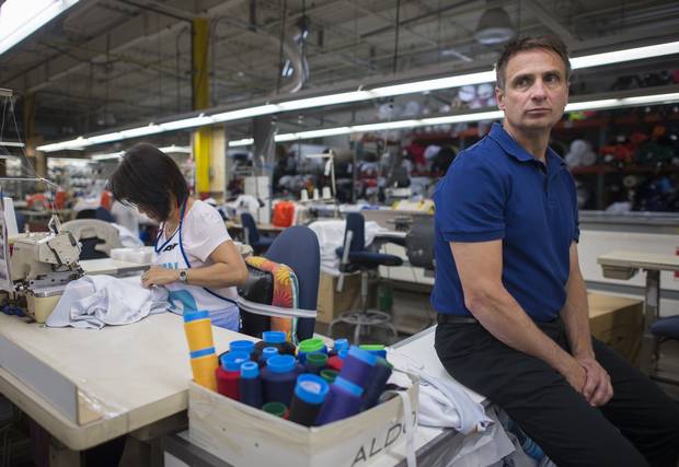 Joe Camillo, owner of Niko Apparel Systems, is photographed by the sewing area in the company's Hamilton, Ont., factory on Sept. 14 2017.