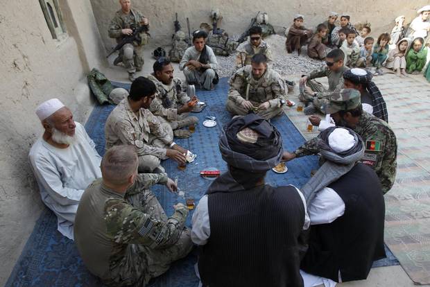 Canadian , US and Afghan army officers sit with local Afghan elders during a meeting in the village of Small Loi Kola in the Panjwai district, in the province of Kandahar June 23 , 2011. Canada will end its combat role in Afghanistan by the end of July, after nearly ten years fighting in the country. 