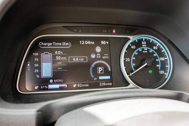Dash displays show the Leaf's current charge and estimated remaining range.