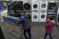 FILE - People shop at a Best Buy store Friday, Nov. 26, 2021, in Overland Park, Kan. U.S. consumer confidence bounced back in March and remains high, though consumers’ short-term outlook is not quite as rosy. The Conference Board, a business research group, said Tuesday, March 29, 2022 that its consumer confidence index — which takes into account consumers’ assessment of current conditions and their outlook for the future — rose to 107.2 in March from 105.7 in February. (AP Photo/Charlie Riedel)