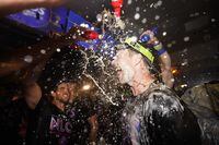 Philadelphia Phillies first baseman Rhys Hoskins is doused after a win over the Atlanta Braves in Game 4 of baseball's National League Division Series, Saturday, Oct. 15, 2022, in Philadelphia. The Philadelphia Phillies won, 8-3. (AP Photo/Matt Slocum)