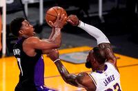 Toronto Raptors guard Kyle Lowry, left, shoots as Los Angeles Lakers forward LeBron James defends during the first half of an NBA basketball game Sunday, May 2, 2021, in Los Angeles. (AP Photo/Mark J. Terrill)