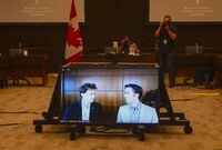 Marc Kielburger, screen left, and Craig Kielburger, screen right, appear as witnesses via video conference during a House of Commons finance committee in the Wellington Building in Ottawa on July 28, 2020. THE CANADIAN PRESS/Sean Kilpatrick