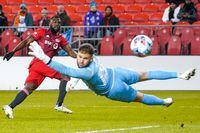 Toronto FC forward Jozy Altidore (17) scores a goal against Pacific FC goalkeeper Callum Irving (13) during first half Canadian Championship semifinal action in Toronto on Wednesday, November 3, 2021. THE CANADIAN PRESS/Evan Buhler