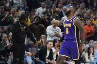 Los Angeles Lakers' LeBron James reacts after hitting a shot during overtime of an NBA basketball game against the Indiana Pacers, Wednesday, Nov. 24, 2021, in Indianapolis. (AP Photo/Darron Cummings) 