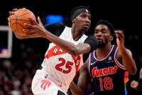 Toronto Raptors forward Chris Boucher (25) looks for the pass as Philadelphia 76ers guard Shake Milton (18) pressures during first half NBA East Division 1st round game 6 basketball action in Toronto, Thursday, April 28, 2022. THE CANADIAN PRESS/Frank Gunn