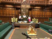Extinction Rebellion activists protest inside the House of Commons in London, Britain September 2, 2022 in this picture obtained from social media. Extinction Rebellion UK/via REUTERS
