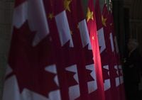 A Chinese flag is illuminated by sunshine in the Hall of Honour on Parliament Hill in Ottawa, Thursday, September 22, 2016. China is threatening retaliation against Canada after Prime Minister Justin Trudeau condemned a new security law giving Beijing more control over Hong Kong.. THE CANADIAN PRESS/Adrian Wyld