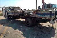 A damaged truck is removed from the site of a suicide bombing, in Sibi, a district in the Pakistan's Baluchistan province, Monday, March 6, 2023. A suicide bomber riding on a motorcycle rammed into a police truck in Pakistan's restive southwest, killing and wounding police officers in one of the deadliest attacks on security forces in recent months, authorities said. (AP Photo/Saeed-ud-Din)