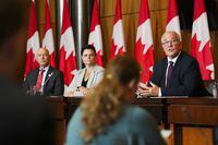 Conrad Sauvé, President and CEO of the Canadian Red Cross, left to right, Janelle Coultes, President of the Search and Rescue Volunteer Association of Canada (SARVAC), Bill Blair, Minister Emergency answer reporters questions during a press conference in Ottawa on Tuesday, July 11, 2023. Four Canadian humanitarian aid groups will use millions of dollars in new funding from the federal government so they can deploy response teams more quickly as climate change increases the demand on their services. THE CANADIAN PRESS/Sean Kilpatrick