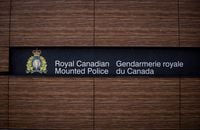 The RCMP logo is seen outside Royal Canadian Mounted Police "E" Division Headquarters, in Surrey, B.C., on Friday April 13, 2018. RCMP have charged two people with arson after an early morning fire Monday destroyed an apartment building in North Battleford, Sask., that forced residents into the bitter cold. THE CANADIAN PRESS/Darryl Dyck